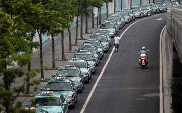 A man walks past a streak of taxis in Hangzhou, Zhejiang Province.