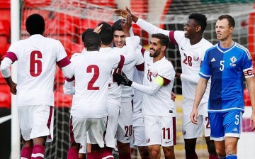 Qatar celebrates a goal in a friendly against Northern Ireland.