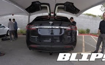 Tesla CEO Elon Musk stands beside the newly launched Tesla Model X.