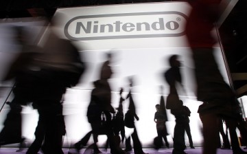 Attendees walk past the Nintendo of America Inc. booth during an Expo in Los Angeles 