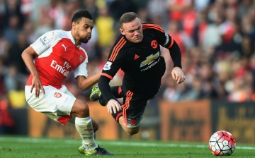 Wayne Rooney of Manchester United is tackled by Francis Coquelin of Arsenal.