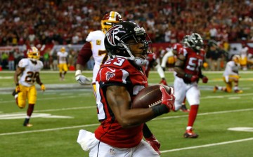 Robert Alford (#23) of the Atlanta Falcons returns an interception for a touchdown in their 25-19 overtime win against the Washington Redskins.