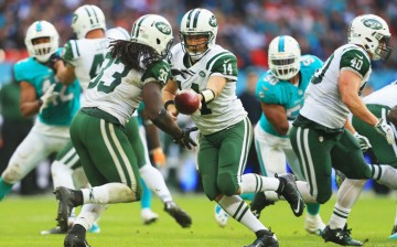 Ryan Fitzpatrick (#14) of the New York Jets hands off to teammate Chris Ivory (#33) during their game against the Miami Dolphins.