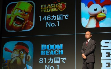 SoftBank Corp. chairman and CEO Masayoshi Son speaks in front of mobile game images of Clash of Clans and Boom Beach by gamemaker Supercell in Tokyo, Japan.