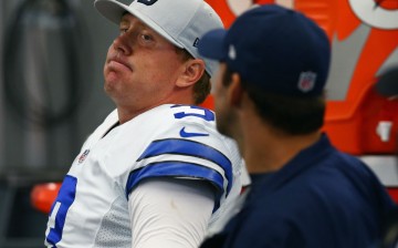 Dallas Cowboys quarterback Brandon Weeden (L) talks with injured Tony Romo on the bench.