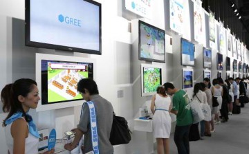Attendees visit the Gree Inc. booth to play the company's mobile game titles during the Tokyo Game Show 2012 at Makuhari Messe on September 20, 2012 in Chiba, Japan. 