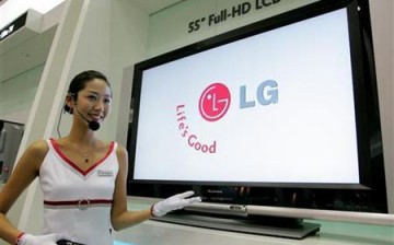 A saleswoman demonstrates the use of an LG Electronics 55-inch Full-HD LCD TV equipped with a liquid crystal display from LG.