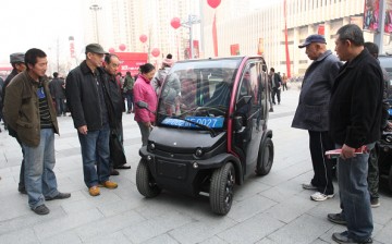 People look at a BIRO City electric vehicle at Wanda Plaza, Yantai, Shandong Province, on Nov. 21, 2014.