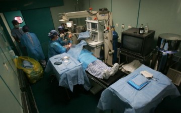 Doctors carry out a cataract removal surgery for a patient on Express May 11, 2008, in Nanyang, Henan Province.