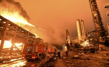 Firefighters try to extinguish a fire in Zhangzhou, Fujian Province, after an explosion hit part of an oil storage facility owned by Dragon Aromatics, in this April 7, 2015 photo.
