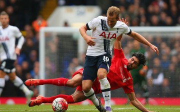 Tottenham striker Harry Kane is tackled by Liverpool midfielder Emre Can.