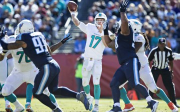 Miami Dolphins quarterback Ryan Tannehill (#17) throws a pass under pressure against the Tennessee Titans.