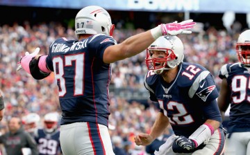 New England Patriots tight end Rob Gronkowski (#87) celebrates after he received a pass from quarterback Tom Brady (#12) for a touchdown.