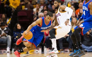 Sixers point guard Ish Smith drives around Cavs' Kyrie Irving.