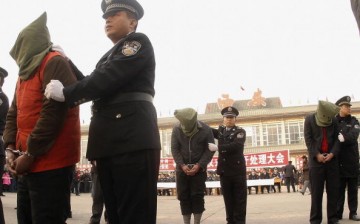 Police parade criminals during a public sentence at the Xian Railway Station in Shaanxi Province, China, in this Jan. 14, 2006 photo. 