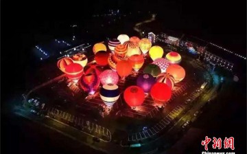 ChinaHot air balloons glow in a field for the Hot Air Balloon Challenge in Enshi Tujia and Miao Autonomous Prefecture, central China's Hubei Province.