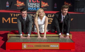 Actors Josh Hutcherson, Jennifer Lawrence and Liam Hemsworth pose at the Stars From Lionsgate's 