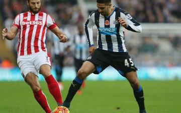 Newcastle United striker Aleksandar Mitrović competes for the ball against Stoke City's Erik Pieters.