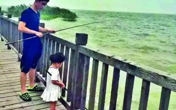 Zhu with daughter Grace trying their luck to catch some fish together.