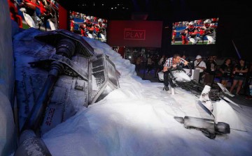 A game enthusiast poses for a photo on a speeder in promotion to 'Star Wars Battlefront' during the Annual Gaming Industry Conference E3 at the Los Angeles Convention Center on June 16, 2015.
