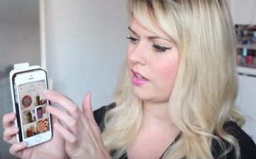 A woman checks out some of the best health & fitness apps on her mobile phone.