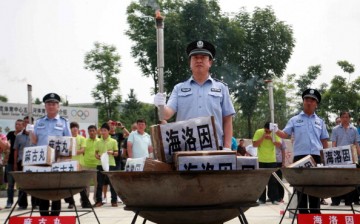 Policemen prepare to incinerate drugs on the International Day Against Drug Abuse and Illicit Trafficking, in Shenyang, on June 26, 2012.