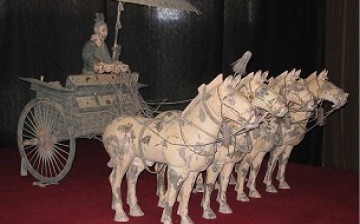 A bronze chariot owned by the First Emperor of China on display in a museum.