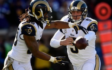 St. Louis Rams quarterback Nick Foles (R) hands off the football to running back Todd Gurley.