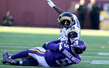 Minnesota Vikings quarterback Teddy Bridgewater (#5) was knocked down by St. Louis Rams' Lamarcus Joyner (#20).