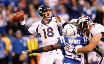 Denver Broncos quarterback Peyton Manning (#18) throws against the Indianapolis Colts.