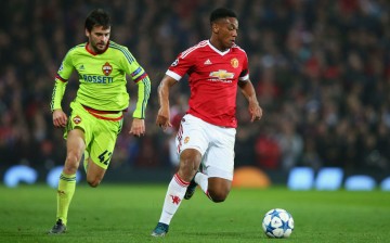 Manchester United striker Anthony Martial (R) dribbles past a CSKA Moscow defender.