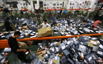 Workers deal with express packages at an assembly line in Wenzhou, Zhejiang Province, Nov. 12, 2014.