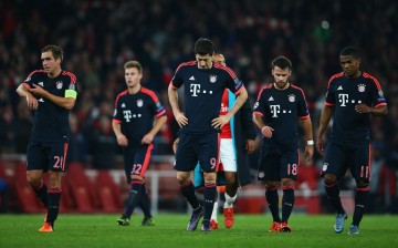 Bayern Munich players walk off the pitch after their loss to Arsenal in a recent Champions League match.