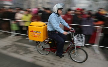 A delivery guy rides his bicycle in Nanjing, Jiangsu Province, on Jan. 18, 2007.