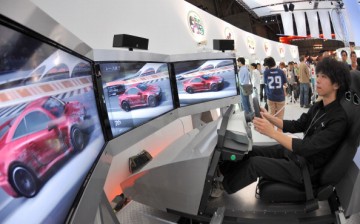 Tokyo Game Show In Tokyo, Japan On September 24, 2009 - A visitor controls a car in a driving game of ' XBOX 360' during Tokyo Game Show 2009 at Makuhari Messe in Chiba Pref.
