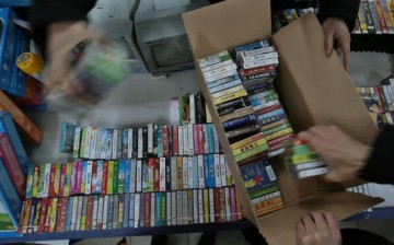 Chinese officials confiscate pirated DVDs during a raid on shops at Nanjing, Jiangsu Province, in this Jan. 17, 2007 photo.