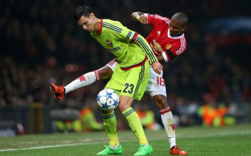 CSKA Moscow midfielder Georgi Milanov competes for the ball against Manchester United's Ashley Young.