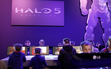 Visitors play a video game 'Halo 5 guardians' at the Paris Game Week, a trade fair for video games on October 28, 2015 in Paris, France. Paris Game week will run from October 28 until November 1, 2015. 