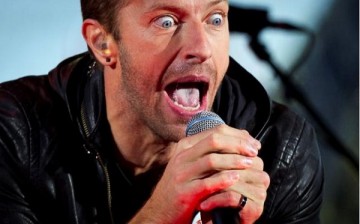 Chris Martin performs with U2 during a surprise concert in support of World AIDS Day in Times Square in New York, December 1, 2014.