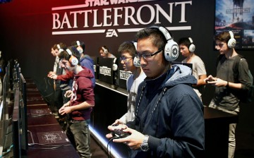  Visitors play a video game 'Star Wars Battlefront' published by Pandemic Studios at the Paris Game Week, a trade fair for video games on October 28, 2015 in Paris, France.