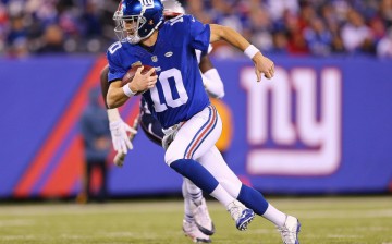 New York Giants quarterback Eli Manning rushes the ball against the New England Patriots.