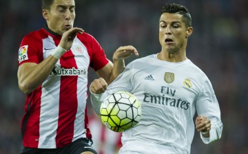 Athletic Bilbao's Oscar De Marcos competes for the ball against Real Madrid's Cristiano Ronaldo.