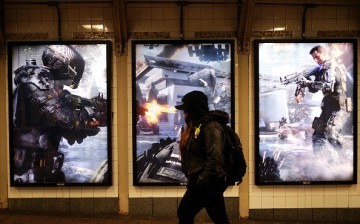 A woman walks past an advertisement of a new video game 'Call of Duty: Black Ops III' in New York on November 19, 2015.
