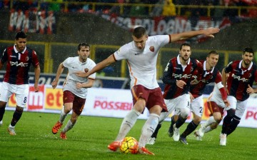 AS Roma striker Edin Dzeko (middle) scores his team's second goal against Bologna from the penalty area.