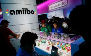 An attendee takes photographs of Super Smash Bros. model characters from Nintendo Co.'s Amiibo game displayed during the E3 Electronic Entertainment Expo in Los Angeles, California, U.S., on Tuesday, June 16, 2015. 