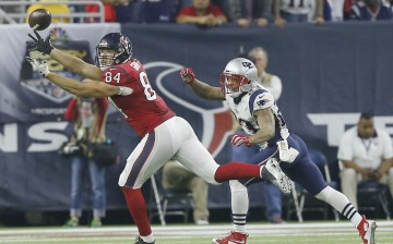 Houston Texans tight end Ryan Griffin (L) catches the ball against New England Patriots' Patrick Chung.