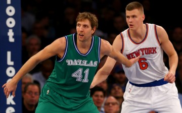 New York Knicks rookie Kristaps Porzingis defends Dallas Mavericks' Dirk Nowitzki.
