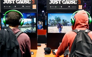  Visitors play a video game 'Just Cause 3' at the Paris Game Week, a trade fair for video games on October 28, 2015 in Paris, France. Paris Game week will run from October 28 until November 1, 2015. 