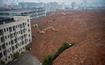 Rescuers work at the landslide site of an industrial park in Shenzhen, south China's Guangdong Province, Dec. 20, 2015. 