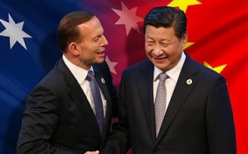 Australian Prime Minister Tony Abbott shakes hand with President Xi Jinping during the signing of a free trade agreement in Canberra in June.